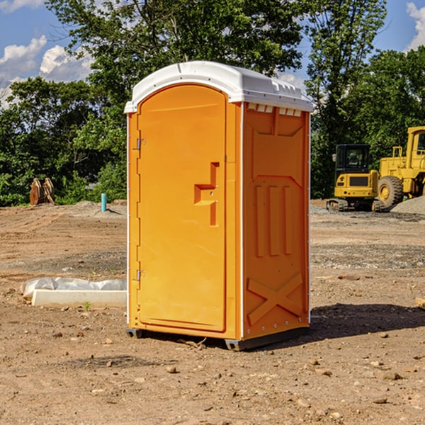 what is the cost difference between standard and deluxe portable restroom rentals in Roundup